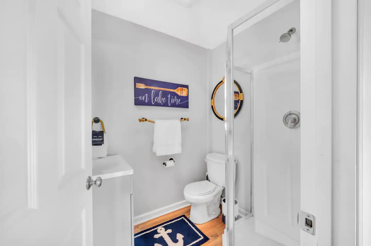 Lower level unattached bath complete with shower, single vanity, & toilet.