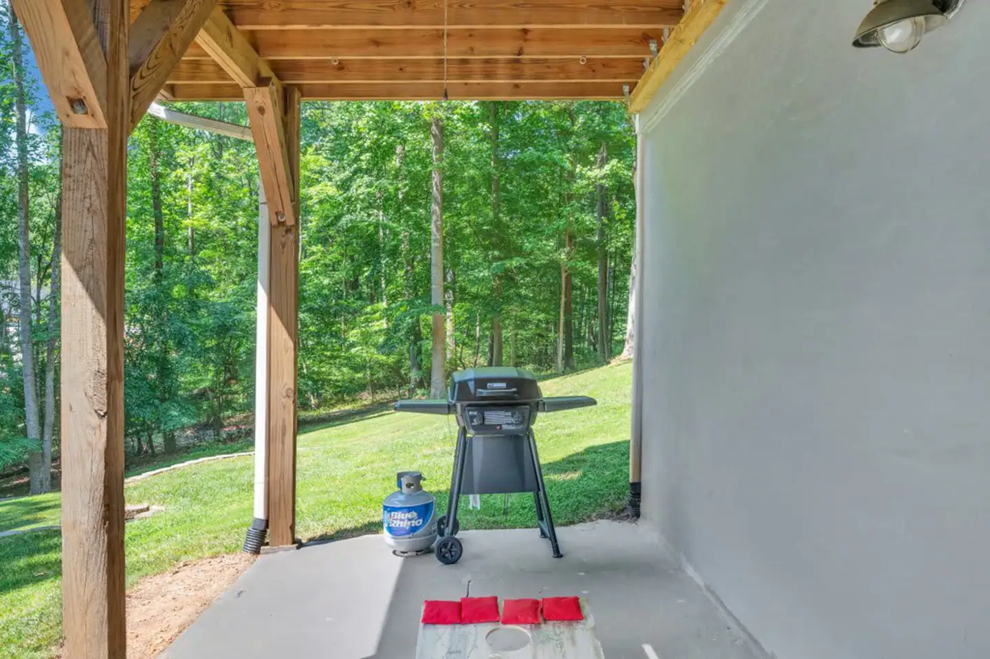 Outdoor Cornhole on Lowe level covered porch. access from downstairs sliding glass doors. Gas Grill has been moved to top level porch)